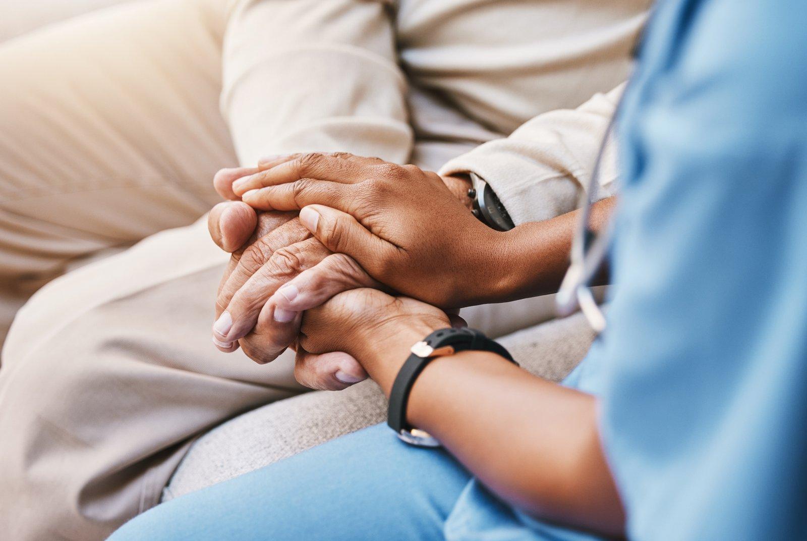 A clinician holding a patient’s hands