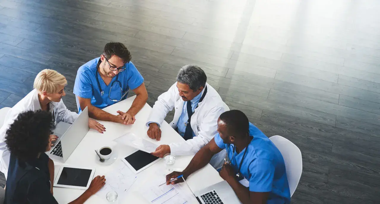 Clinicians meeting around a table