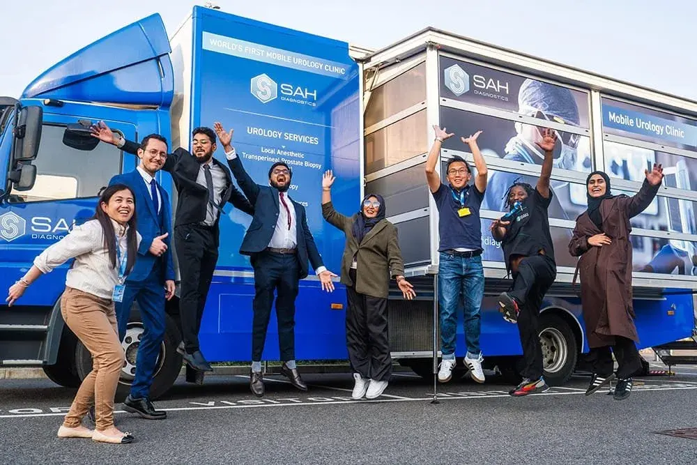 The SAH team celebrating in front of a mobile unit