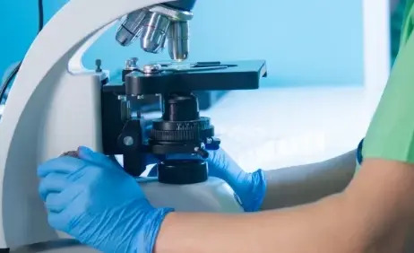 A scientist working at a laboratory microscope