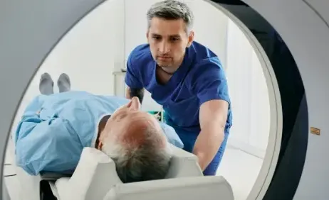 A radiographer positioning a patient for a CT scan