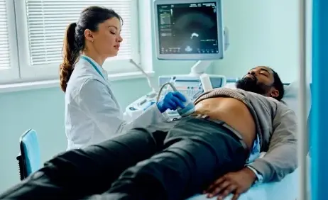 A clinician carrying out an ultrasound scan