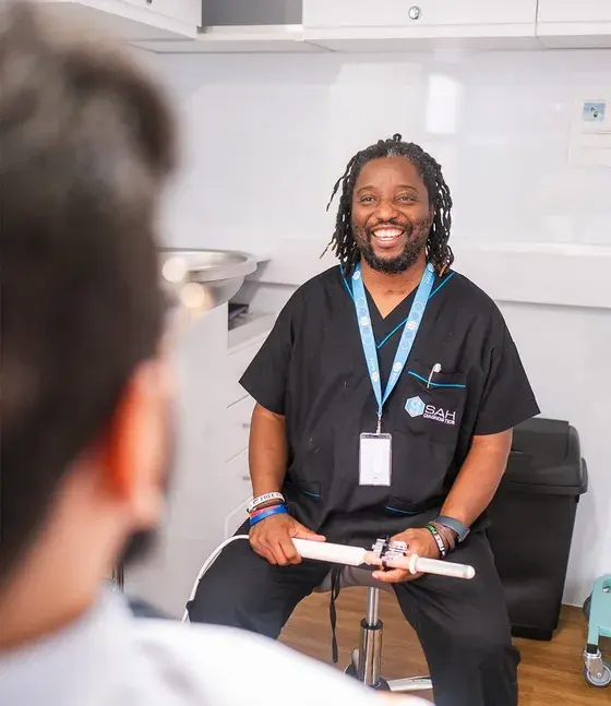 An SAH clinician talking with a patient in the unit’s consultation room
