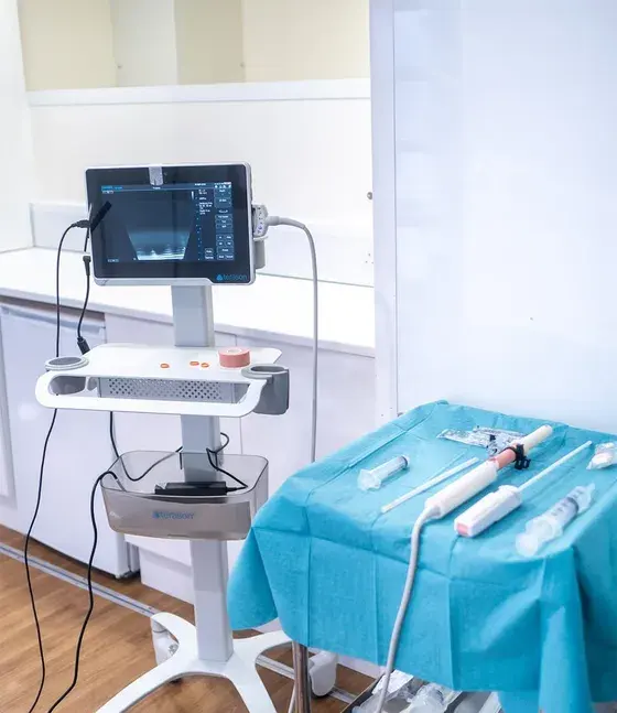 An ultrasound system beside a sterile trolley inside the unit